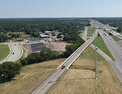 An aerial view of the site for the ABC project on I-635. The two bridges over Seagoville Road that will be replaced are to the right. The fabrication yard for the prebuilt bridge sections is located to the left. Photo credit: TxDOT