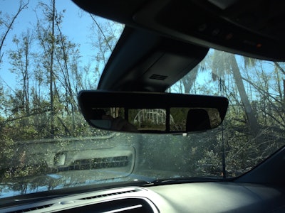 Rear-view prior to using the rear camera mirror. Head rests and rear window obstruct the view.