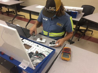 Bayden Baucom, sponsored by the Carolina Cat dealership, builds simple series circuits and checks voltage drops during lab at Florence-Darlington Technical Community College.
