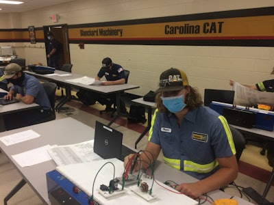 Students in Florence-Darlington Technical Community College’s Caterpillar ThinkBig program work on electrical circuits while adhering to social-distancing and mask requirements. Blanchard Machinery, Carolina Cat and Gregory Poole dealerships all hire and sponsor students in the program.