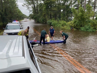 Walton County sheriff’s officers rescued this man who has waist-deep water in his home. Photo credit: Walton County Sheriff’s Office