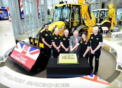 Celebrating the production of the 750,000th JCB backhoe loader at JCB World headquarters, Rocester, Staffordshire, England. Lord Anthony Bamford, JCB chairman, is pictured third from right.