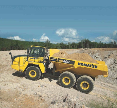 Komatsu’s HM400-5 is powered by a Komatsu engine rated at 469 horsepower. Gross vehicle weight is 165,644 pounds and payload capacity is 44.1 tons. The low 10-foot, 5-inch load height is a good match for 40- to 60-ton excavators or 5.5- to 7.5-cubic-yard wheel loaders. A lightweight fiberglass hood features an electrically powered tilt function as standard equipment.