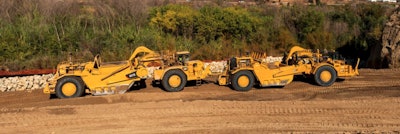 A Cat 657 scraper and its predecessor Cat 657G in push-pull mode.