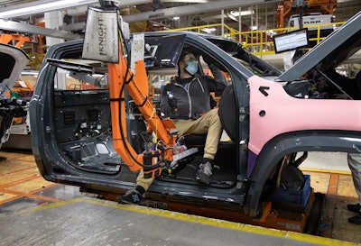 An employee at FCA’s Sterling Heights (Mich.) Assembly Plant uses a “happy seat” to work in the cab of the first Ram 1500 TRX Launch Edition, adorned in an exclusive Anvil exterior paint. FCA invested nearly $1.5 billion to retool the plant to build the next generation Ram 1500, which launched in 2018, and support the future growth of the Ram brand.