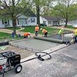 Men using custom drum to pave concrete