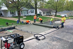 Men using custom drum to pave concrete