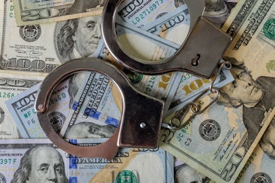 Handcuffs on top of U.S. currency