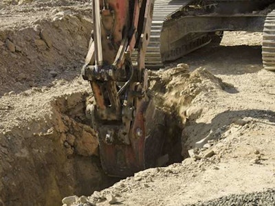 Excavator being used to dig a trench