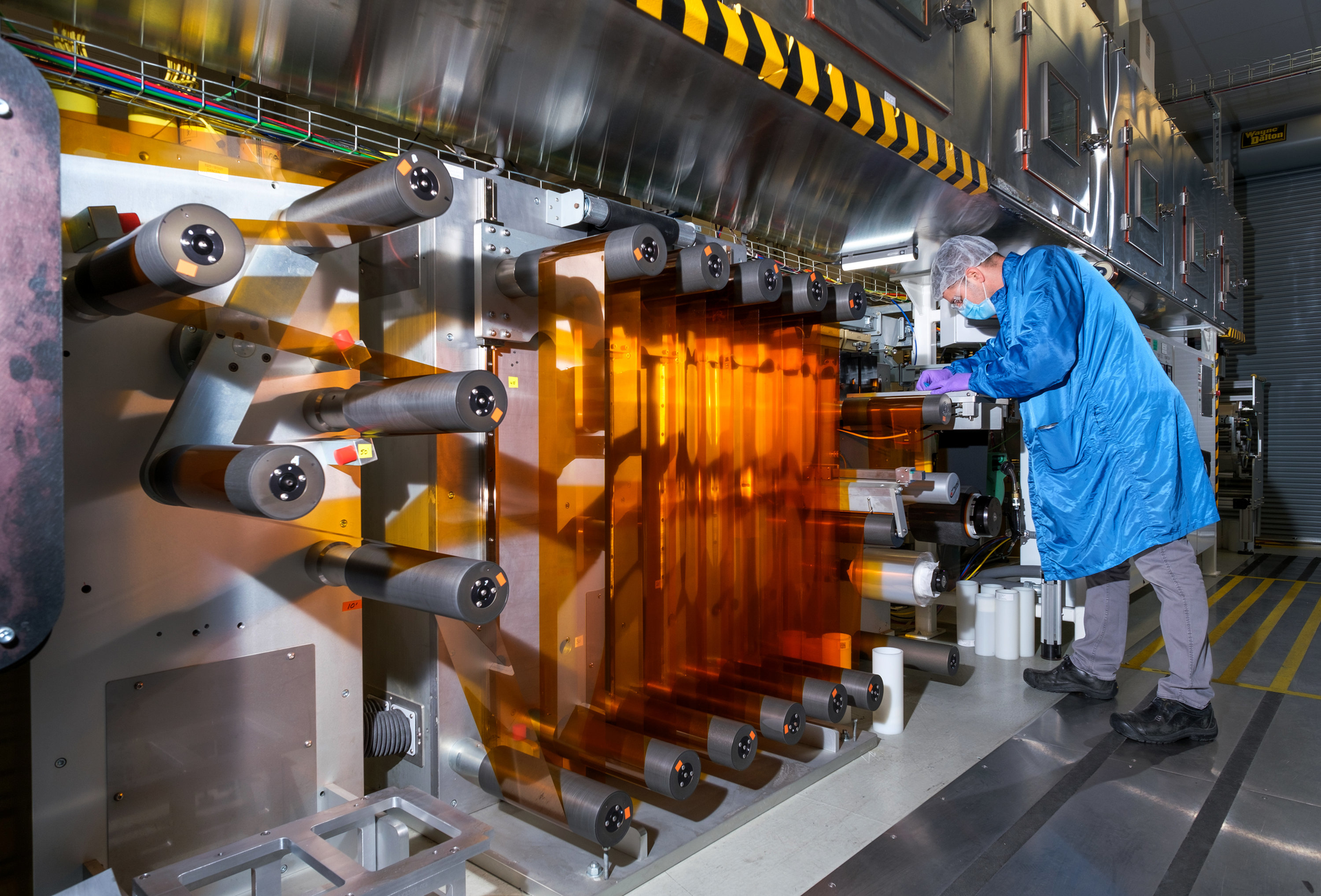General Motors Fuel Cell Controls and Process Engineer Joe Truchan operating a coating machine