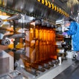 General Motors Fuel Cell Controls and Process Engineer Joe Truchan operating a coating machine