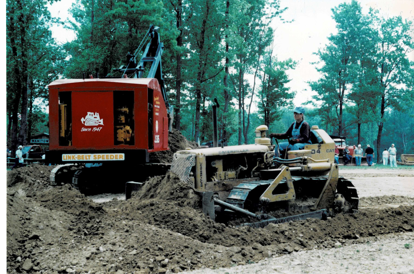 Nancy McDonnell pushes dirt for a crawler crane at an antique construction equipment show.