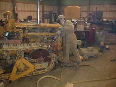 Nancy McDonnell working on 1956 Cat D4 dozer