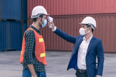 construction worker gets temperature taken at jobsite