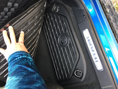 Under the floor mat in the back you’ll find Ram storage bins. Nice!