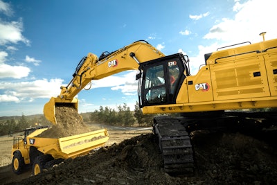 Cat 374 excavator moving dirt into cat 745 Articulated Haul Truck