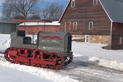Holt Caterpillar 10-Ton tractor surrounded by snow in front of barn in St. Stephen, Minnesota