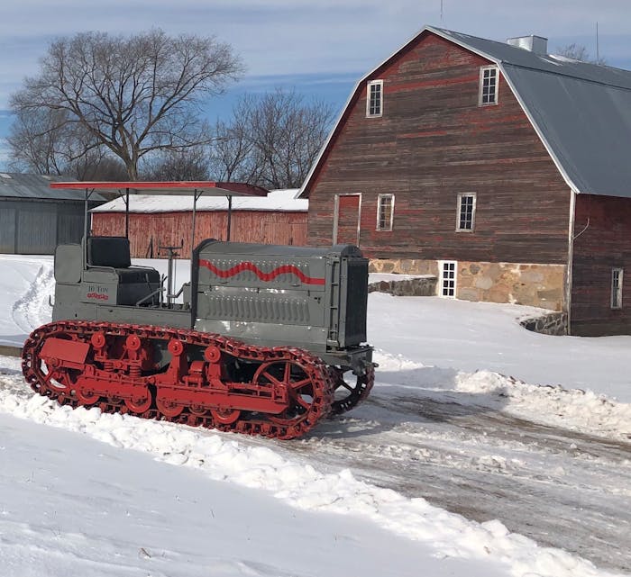 Holt Caterpillar 10-Ton tractor surrounded by snow in front of barn in St. Stephen, Minnesota