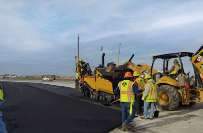Workers paving asphalt