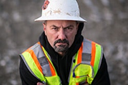 Construction worker with arms crossed