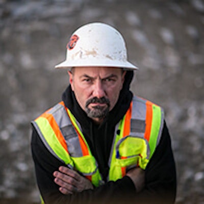 Construction worker with arms crossed