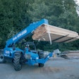 Genie GTH-1056 telehandler moving lumber