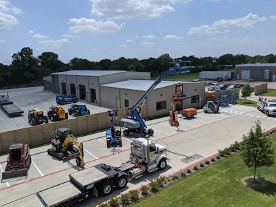 H&E Equipment Services store in McKinney, Texas with construction equipment parked around building
