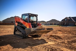 Kubota SVL97-2 compact track loader in residential neighborhood