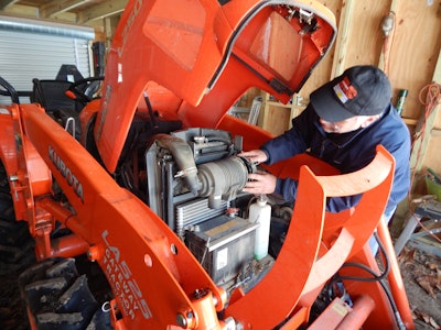 Robert Braswell working on a piece of Kubota equipment