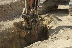 Excavator being used to dig a trench