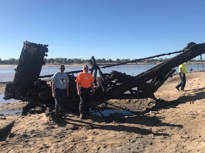 Bill, left, and Mike Oberloier first see their dad's crane after Wixom Lane drained following the Edenville Dam break.