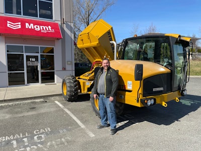 Mike MacKenszie, sales manager of MGMT Group standing beside a Hydrema 707G articulated dump truck