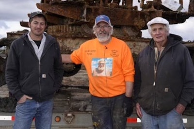 Mike Oberloier wore an orange sweatshirt with his father's picture on the front on the day of the rescue. Here he poses with Thew steam shovel owner Bob Kelly, right, and Kelly's grandson Tommy.