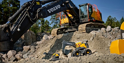 volvo excavator next to volvo toy excavator