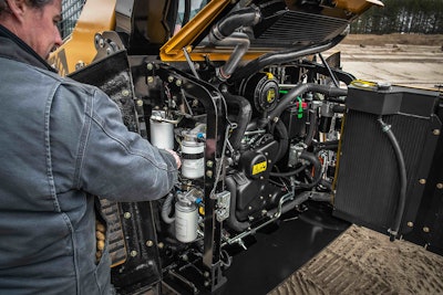 man performing maintenance work on heavy duty equipment