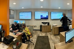 Work room with people at desks on computers