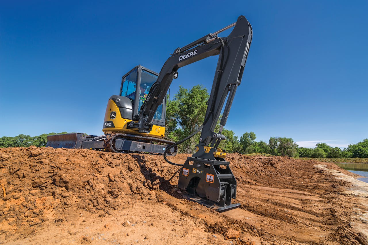 compact excavator with deer plate compactor attachment