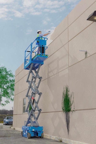 Worker painting exterior of building in scissor lift