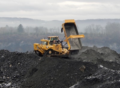 Worker operating cat equipment on construction site