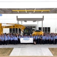 Kobelco machine surrounded by employees