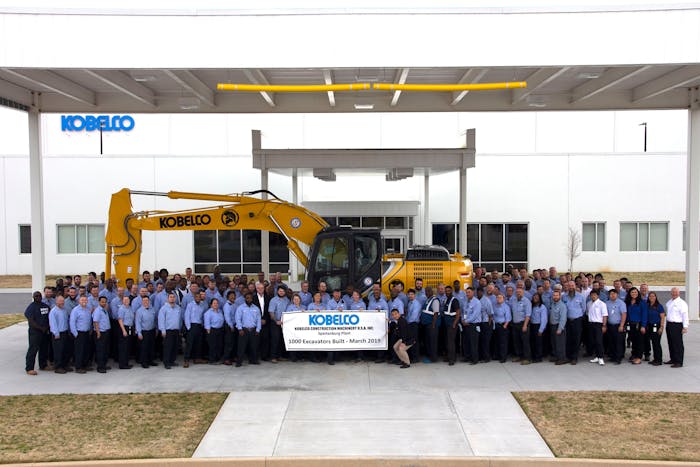 Kobelco machine surrounded by employees