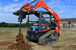man operating kubota equipment with auger attachment