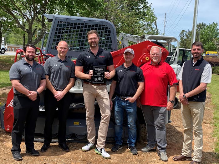 Cobb County Tractor company photo receiving Takeuchi dealer award