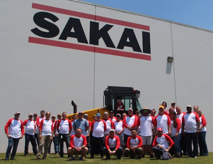 sakai workers having picture taken outside facility