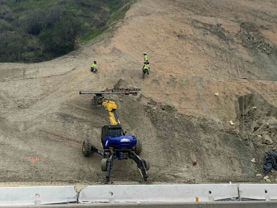 spider excavator at work on steep hill