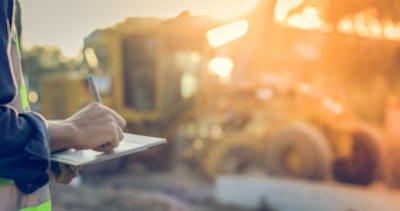 person taking notes on construction job site