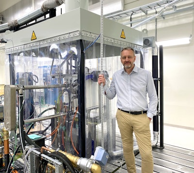 man next to hydrogen fuel cell test lab