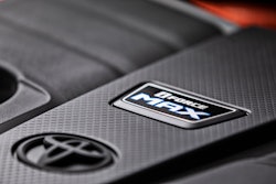 Toyota teased another image of its all-new 2022 Toyota Tundra. This one shows the top of the new engine cover and an orange blur in the background which may suggest a hybrid powertrain.