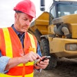 Contractor using phone on jobsite