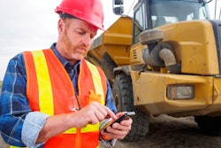 Contractor using phone on jobsite